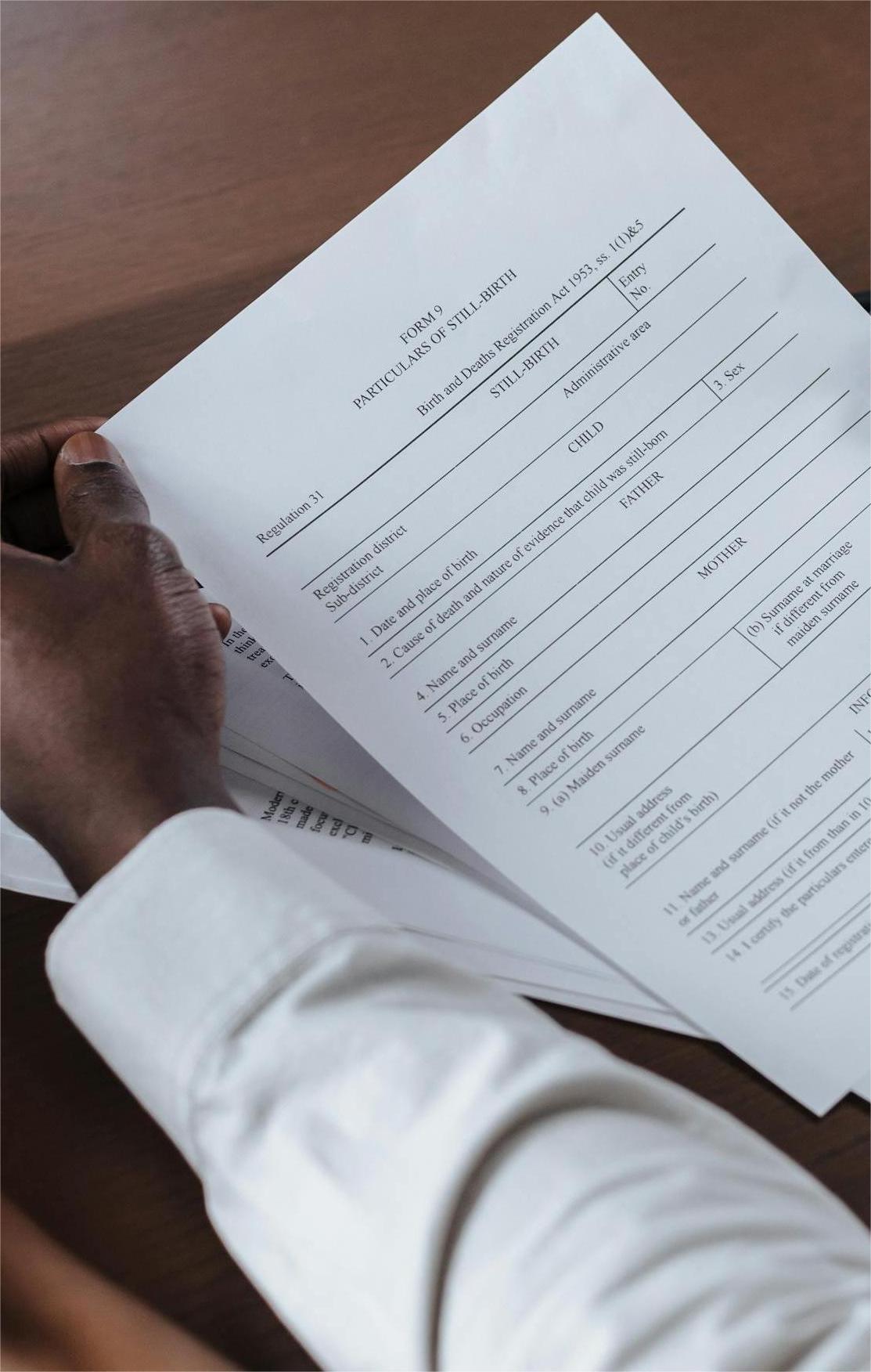 Male lawyer looking at client reading contract
